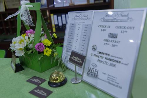 a table with a sign and a bouquet of flowers at Hotel Villa Natali in Chişinău