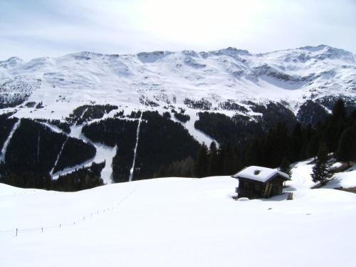 a small cabin in the snow with a mountain at Albergo Thurwieser in Santa Caterina Valfurva