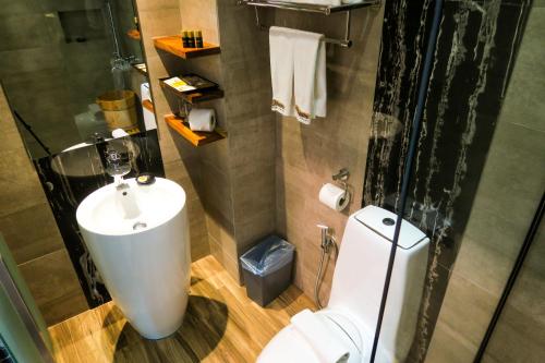 a bathroom with a toilet and a sink at Le Dream Boutique Hotel in George Town