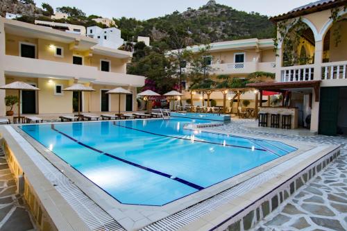 a large swimming pool in front of a hotel at Kyra Panagia Hotel in Kyra Panagia