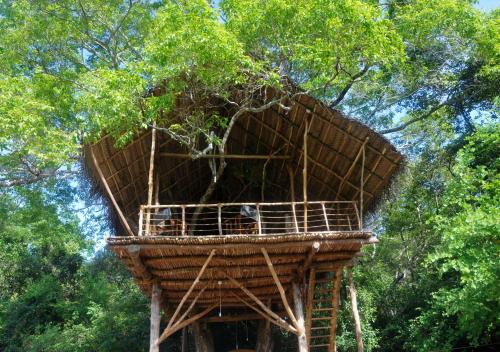 a tree house in the middle of a forest at Back of Beyond - Wild Haven in Sigiriya