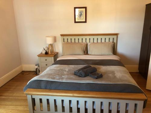 a bed with a pair of socks and a hat on it at Riverbank villa in Devonport