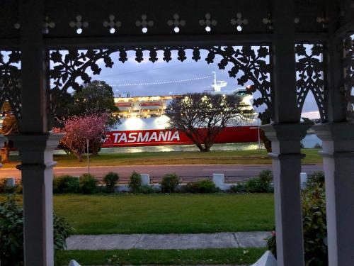a gate with a train in the background at Riverbank villa in Devonport