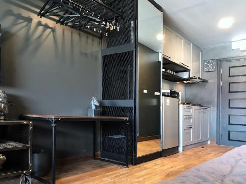 a kitchen with a table and a refrigerator at Stay in Style at Nimman R911 in Chiang Mai