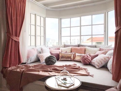 a living room with a couch with a large window at Stay in Style at Nimman R912 in Chiang Mai