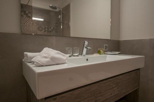 a bathroom with a white sink and a mirror at Focus Hotel in Sursee