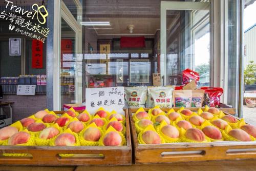 a store with a display of apples and other fruit at Nantou Fruit House in Renai