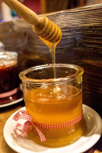 a honey bee being dripped into a jar of honey at Tasia Mountain Hotel in Chania