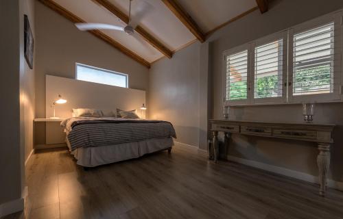 a bedroom with a bed and a window at Umhlanga Lodge in Durban