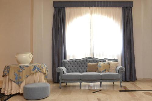 a living room with a couch and a window at Hotel Anthony in Lido di Jesolo
