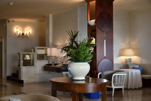 a living room with a vase on a table at Hotel Anthony in Lido di Jesolo