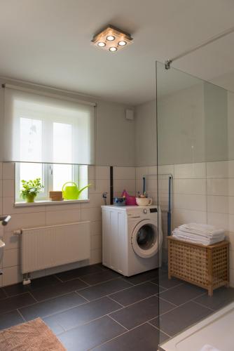 a bathroom with a washing machine and a window at An der Günz in Waldstetten