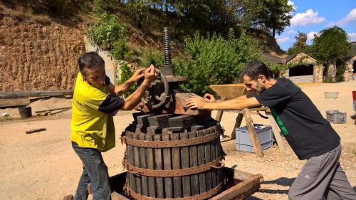 two men are playing with a barrel with at La ferme des Cévennes in Florac Trois Riviere