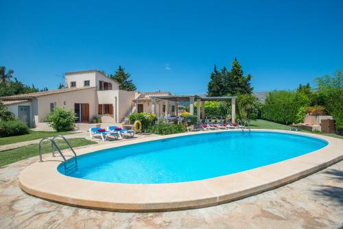 una piscina di fronte a una casa di Owl Booking Villa Coloma - Luxury Retreat with Huge Pool a Port de Pollença