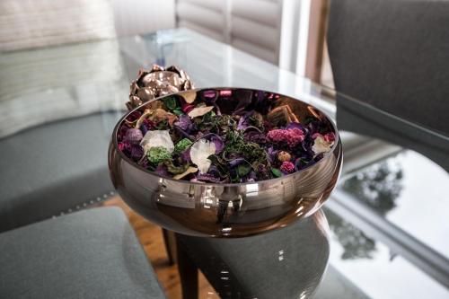 a bowl of flowers sitting on a glass table at Valmont Estate in Plettenberg Bay