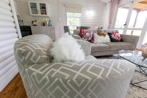 a living room with a couch and a chair at Valmont Estate in Plettenberg Bay