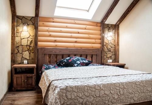 a bedroom with a large bed with a wooden headboard at Russkiy dvor in Izhevsk