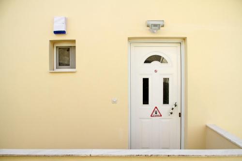 a white door on the side of a building at Apartment for Family 2 in Kallithea Halkidikis