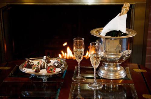 a table with a plate of food and glasses of champagne at Cleftstone Inn in Bar Harbor