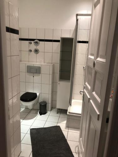 a small bathroom with a toilet and a sink at City-Apartment Zille in Berlin