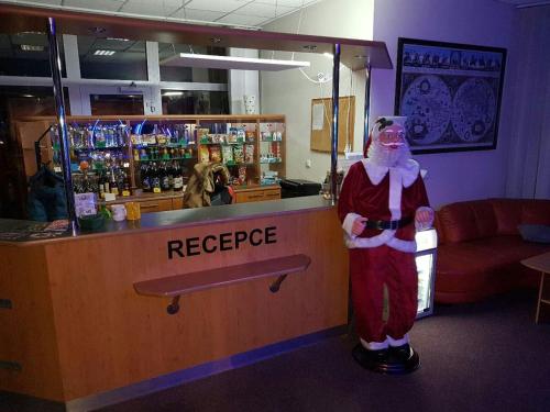 a person dressed as a santa standing at a counter at U Betty - Ostrava Centrum in Ostrava