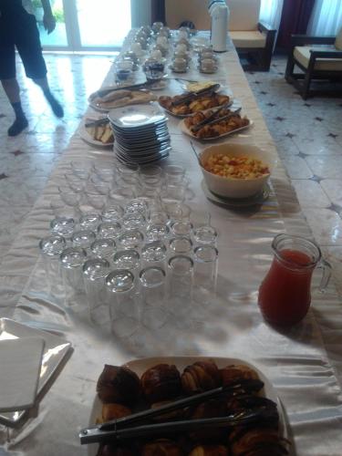 a long table topped with glasses and plates of food at Andasibe Lemurs Lodge in Andasibe
