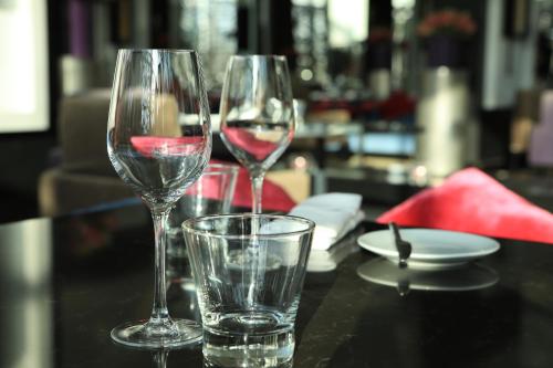two wine glasses and a glass of water on a table at Sofitel Casablanca Tour Blanche in Casablanca