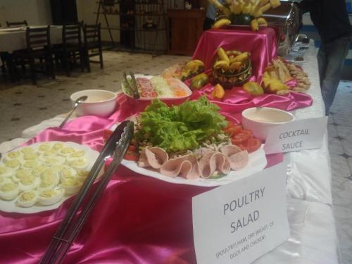 a table with different types of food on it at Andasibe Lemurs Lodge in Andasibe