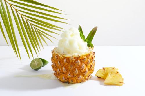 a pineapple with whipped cream and a lime at de Braga, ARTOTEL Curated in Bandung