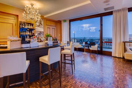 a restaurant with a bar with a view at Grande Albergo Roma in Piacenza