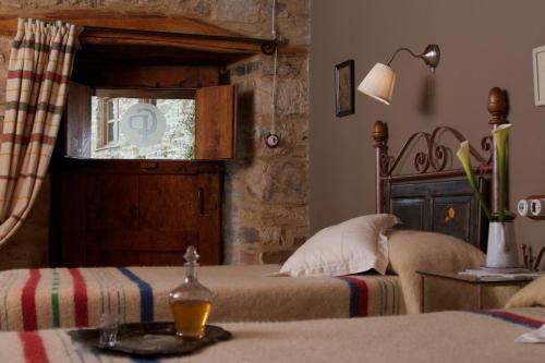 a bedroom with a bed and a window at Casa Pepa Hotel Rural in Santa Colomba de Somoza