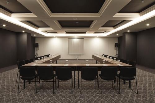 a conference room with a large table and chairs at de Braga, ARTOTEL Curated in Bandung
