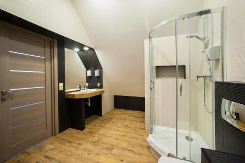 a bathroom with a shower and a sink at Hotel Gentleman in Ternopilʼ