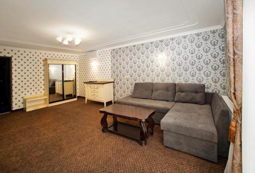a living room with a couch and a table at Hotel Gentleman in Ternopilʼ