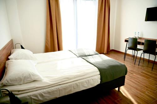 Un pat sau paturi într-o cameră la Simar