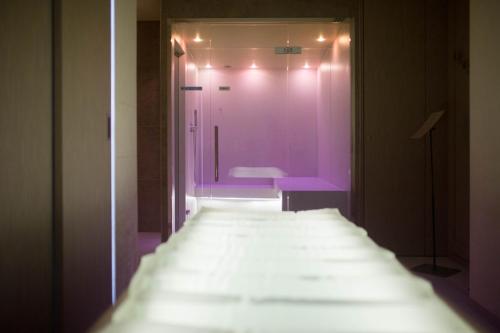a bathroom with a purple door and a sink at Grande Albergo Roma in Piacenza