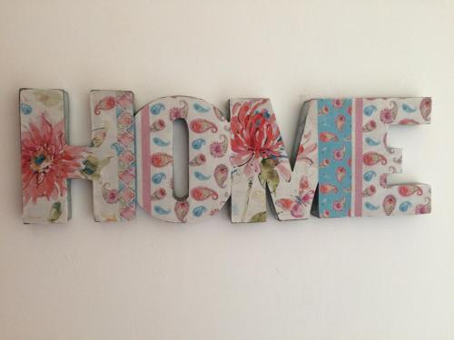 a word made out of flowers on a wall at LA VILLA BOLERO in Saint-Cyr-sur-Loire