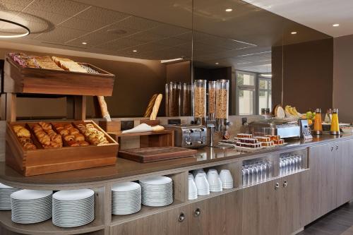 a bakery with a counter with plates and pastries at Auteuil Tour Eiffel in Paris