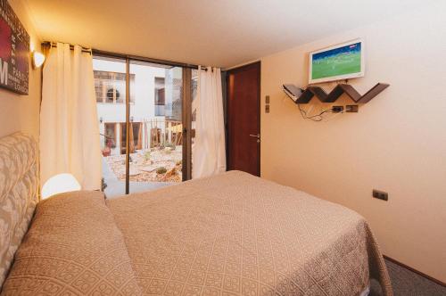 a bedroom with a bed and a sliding glass door at Bella 269 Guest house in Santiago