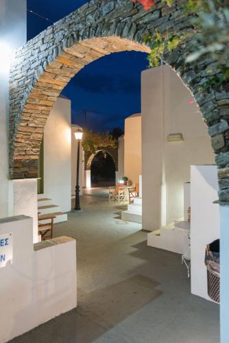 an archway in a building with tables and chairs at Giannakas Studios in Platis Yialos Sifnos