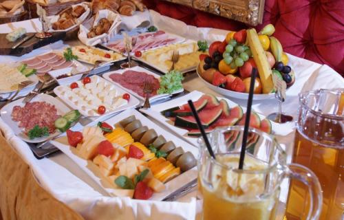 a table topped with lots of different types of food at Snow Pearl Residence & FREE SPA in Bansko
