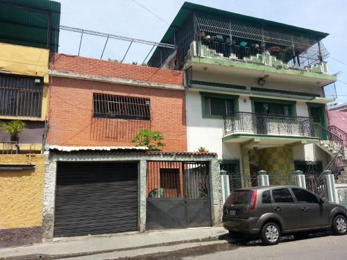 a car parked in front of a building with a balcony at Candida in Caracas