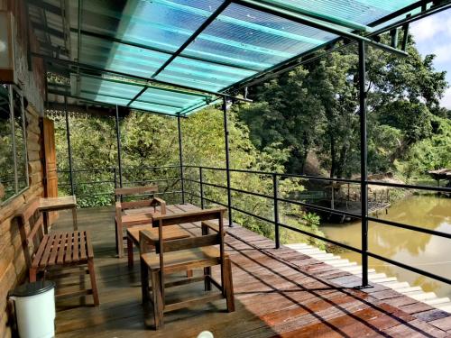a balcony with benches and a view of a river at Dreamhome Chiangdao in Chiang Dao