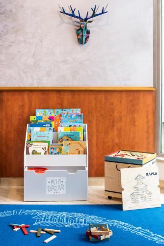 two boxes filled with toys sitting on the floor at Aparthotel Adagio Annecy Centre in Annecy