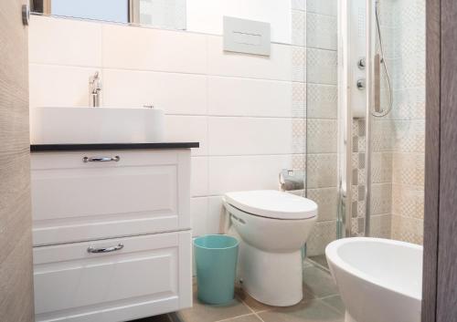 a bathroom with a white toilet and a sink at Interno2 Bari Centrale in Bari