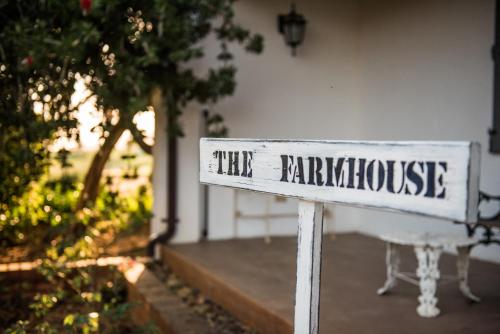 a white sign that reads the bath house at White Water Farm in Stanford
