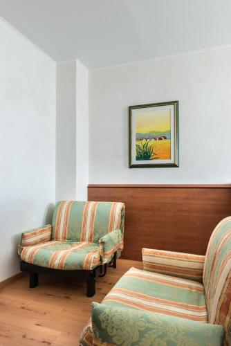 a living room with two chairs and a couch at Point Hotel in Piove di Sacco