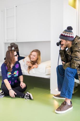 a man taking a picture of two women in a hospital room at Sant Jordi Hostels Rock Palace in Barcelona