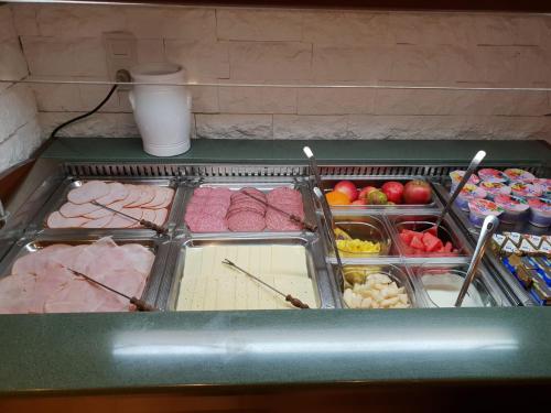 a refrigerator filled with different types of food at Hotel zum Goldenen Wagen in Maulburg