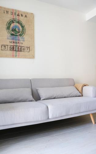 a couch in a room with a white wall at Apartamentos Plaza Mayor in Gijón